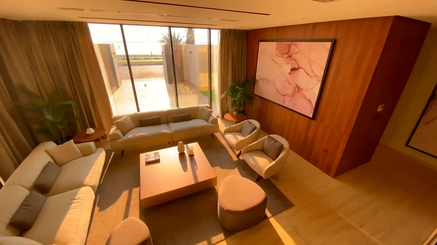 Cream sofas around a walnut coffee table